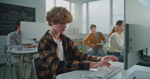 Student in Checkered Shirt Doing Examination Project on Game Development Stock Footage 318523538