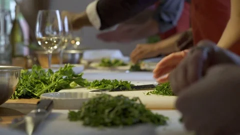 Student chefs clearing parsley off cutting boards 動画素材 77081672