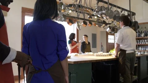 Student chefs gathering in a kitchen Stock Footage 77081550