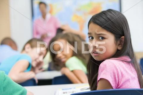 Student in class being bullied by students in background (selective focus) Stock-Fotos