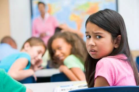 Student in class being bullied by students in background (selective focus) Stock Photos