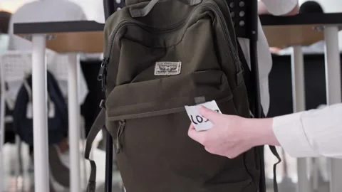 Student in class hangs a note on his backpack that says Loser. Stock Footage 264511944