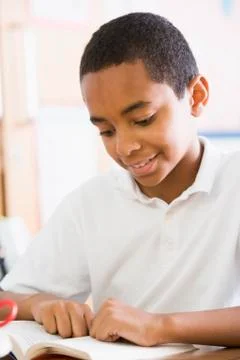 Student in class reading book (high key) Stock Photos