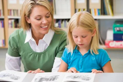 Student in class reading with teacher Stock Photos