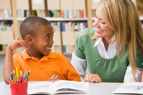 Student in class reading with teacher Stock Photos