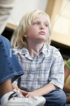 Student in class sitting on floor bored (selective focus) Stock Photos