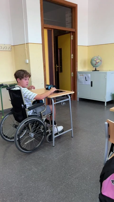 A student in class sitting in a wheelchair. Back to school concept Stock Footage 248953987