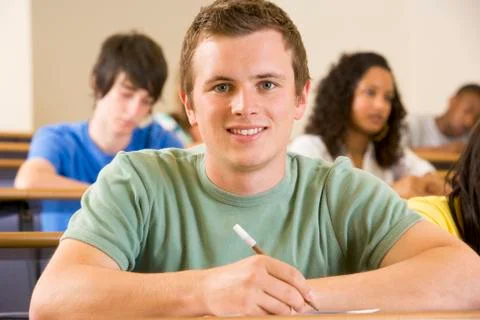 Student in class taking notes (selective focus) Stock Photos