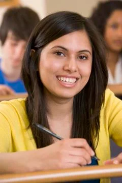 Student in class taking notes (selective focus) Stock Photos