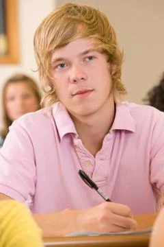 Student in class taking notes (selective focus) Stock Photos
