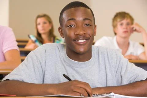 Student in class taking notes (selective focus) Stock Photos