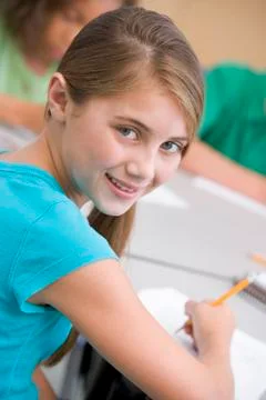 Student in class taking notes (selective focus) Stock Photos