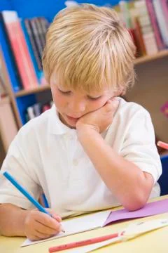 Student in class writing in notebook (selective focus) Stock Photos