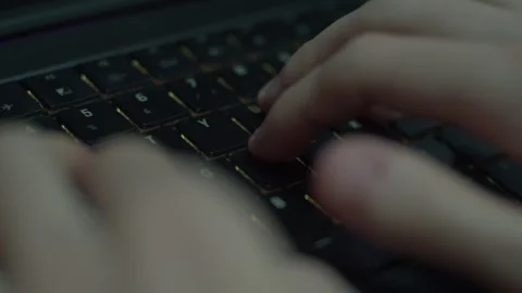 Student close typing on keyboard with RGB Stock Footage 265177009