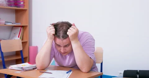 Student clutched head in horror and nervously examined piece of paper. Stock Footage 222672716