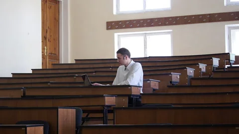 Student Coming To Empty Classroom And Using Laptop Stock Footage 284937718