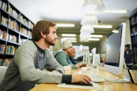 Student, computer and studying in university library for programming course Stock Photos