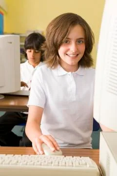 Student at computer terminal with student in background (selective focus) Stock Photos