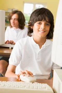 Student at computer terminal with student in background (selective focus) Stock Photos