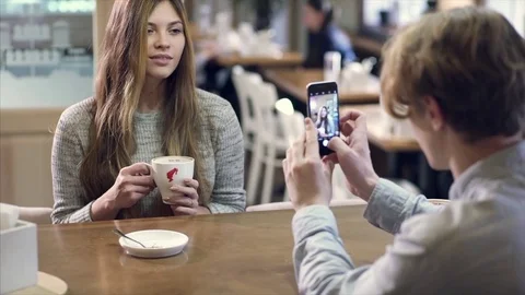 Student couple chatting together in a cafe Stock Footage 70973908