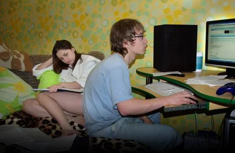 Student couple on the sofa study notes and prepare for exams. Stock Photos