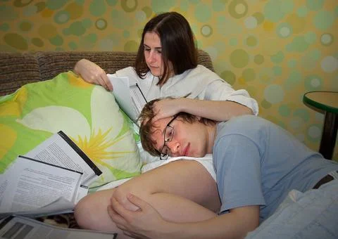 Student couple on the sofa study notes and prepare for exams. 写真素材