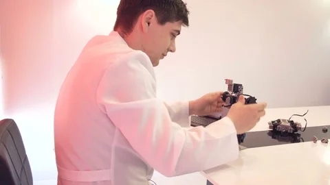 The student creates a robot in the laboratory Stock Footage 77267279