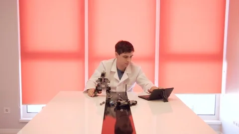 The student creates a robot in the laboratory Stock Footage 77269557
