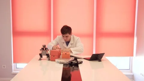 The student creates a robot in the laboratory Stock Footage 77269756