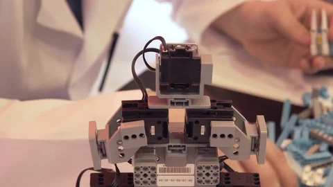 The student creates a robot in the laboratory Stock Footage 77271514