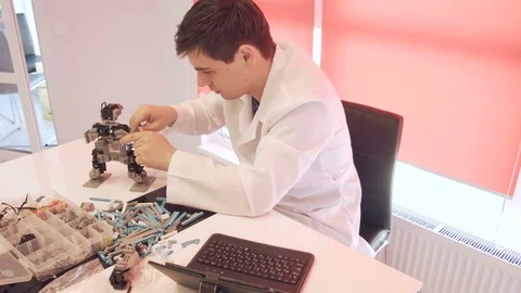 The student creates a robot in the laboratory Stock Footage 77272967