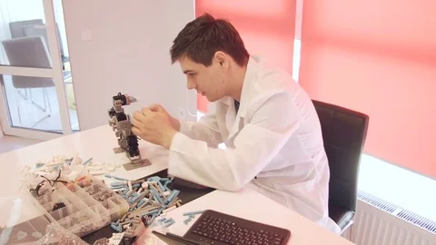 The student creates a robot in the laboratory Stock Footage 77274083