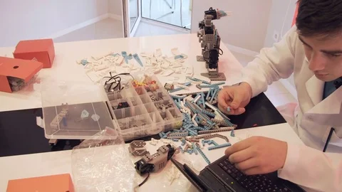 The student creates a robot in the laboratory Stock Footage 77274317