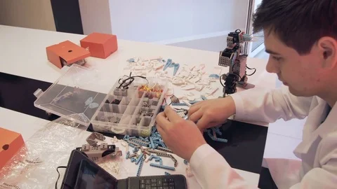 The student creates a robot in the laboratory Stock Footage 77274632