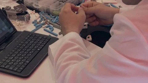 The student creates a robot in the laboratory Stock Footage 77416211