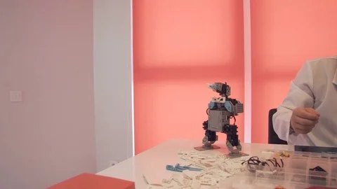 The student creates a robot in the laboratory Stock Footage 77417103