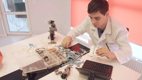 The student creates a robot in the laboratory Stock Footage 77417562