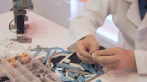The student creates a robot in the laboratory Stock Footage 77417982