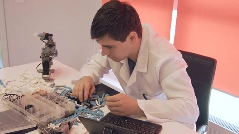 The student creates a robot in the laboratory Stock Footage 77418232