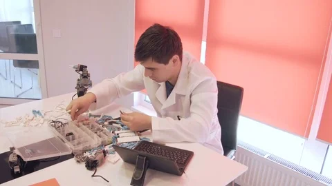 The student creates a robot in the laboratory Stock Footage 77418735