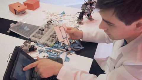 The student creates a robot in the laboratory Stock Footage 77419097