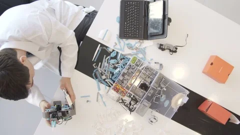 The student creates a robot in the laboratory Stock Footage 77420651