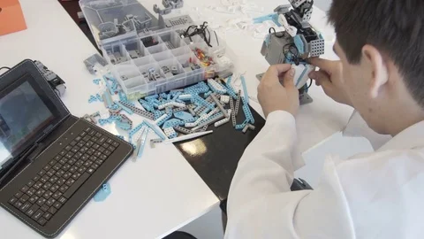 The student creates a robot in the laboratory Stock Footage 77421529
