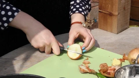 Student cuts an onion outside Stock Footage 104142087