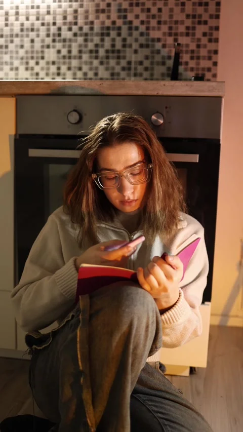 Student distracted by phone during studying Video stock 334056732
