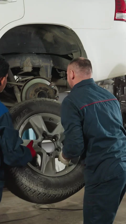 Student Documenting Mechanics Fixing Car in Auto Repair Workshop Stock Footage 318251359