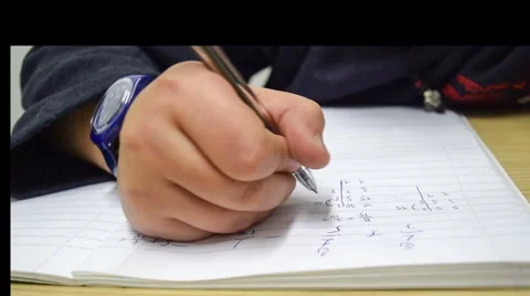 Student doing his mathematics homework in a study room. Stock Footage 58933681