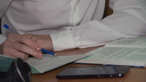 Student doing homework at recess. Soon the call to the lesson, have to run. Stock Footage 100033937