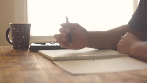 A student doing math homework on a table Stock Footage 94015474