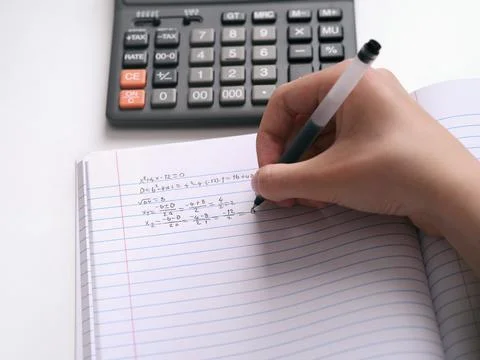 A student doing math in a notebook. Close up. Foto stock